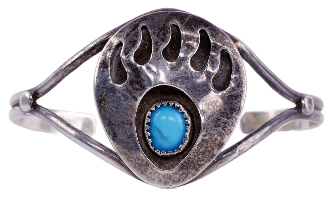 NAVAJO STERLING SILVER TURQUOISE BEAR PAW CUFF: Navajo sterling silver bear paw cuff with turquoise. Bracelet is unmarked acid test for sterling silver. Paw 1.25 x 1 inches. Cuff diameter 2.5 inches. This lot has a reserve.