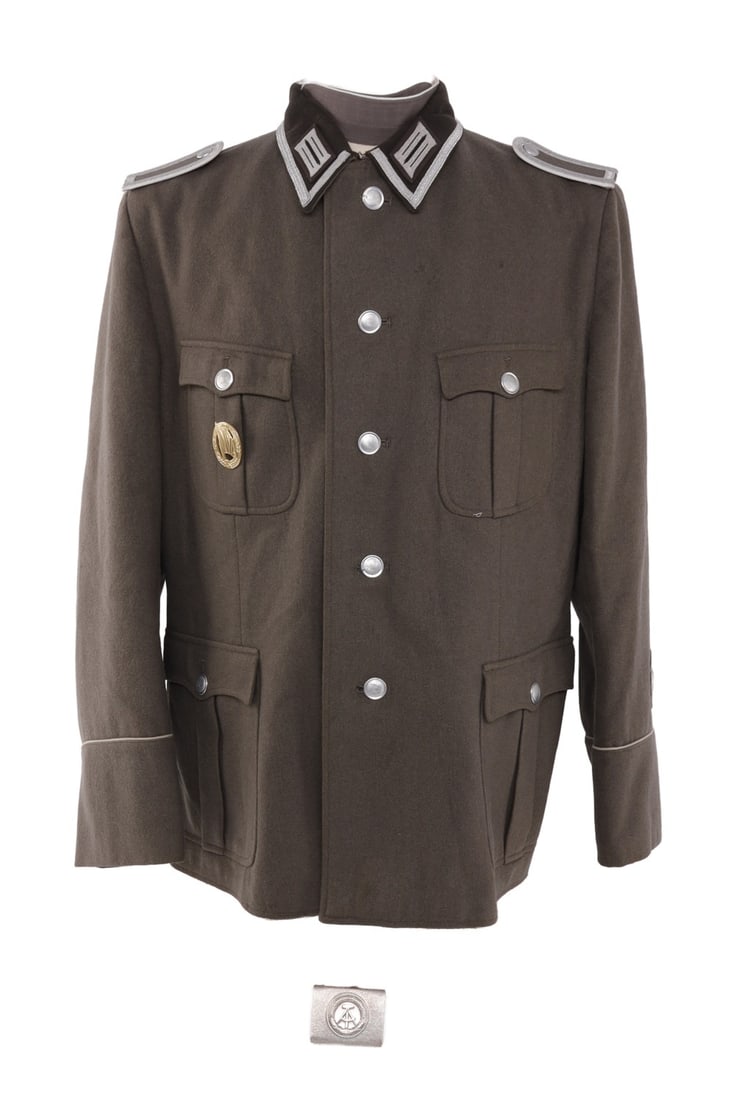 EAST GERMAN NVA DDR WOOL OFFICER'S TUNIC G60 XXL: East German officer's tunic of grey wool. Size marked "G60," or XXL. Right breast pocket has rifle qualification badge. Retains shoulder boards, collar tabs. Sleeve has winged wheel insignia patch. Al