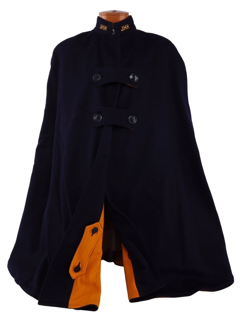 WWII JOHNS HOPKINS HOSPITAL WOOL NURSE'S CAPE: Nurse's cape of navy blue wool with bright mustard yellow liner. Collar has "J.H.H." (Johns Hopkins Hospital). Liner has tailor's label "Hopkins Nurses Uniform Co. 1822 E. Monument St. Baltimore, MD."