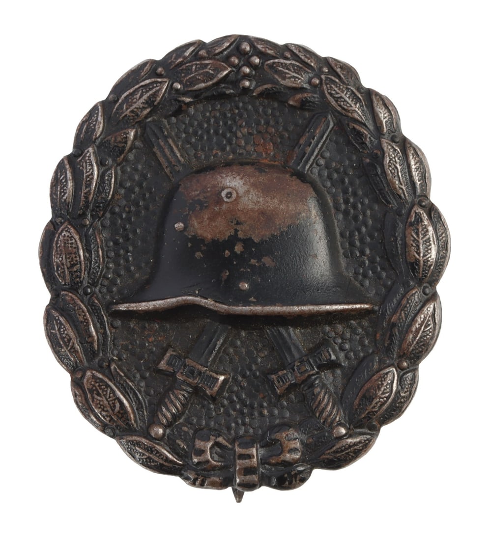 WWI IMPERIAL GERMAN WOUND BADGE IN BLACK: A Wound Badge in black. A Stahlhelm over crossed swords inside a wreath. 2 inches.