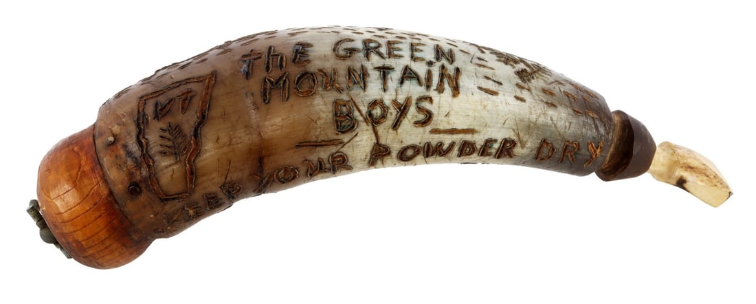 REVOLUTIONARY WAR ETHAN ALLEN POWDER HORN: A carved powder horn commemorating Ethan Allen. Carved text on horn reads "The Green Mountain Boys Keep Your Powder Dry Ethan Allen 1879." This is a commemorative item and is not original to the Ameri