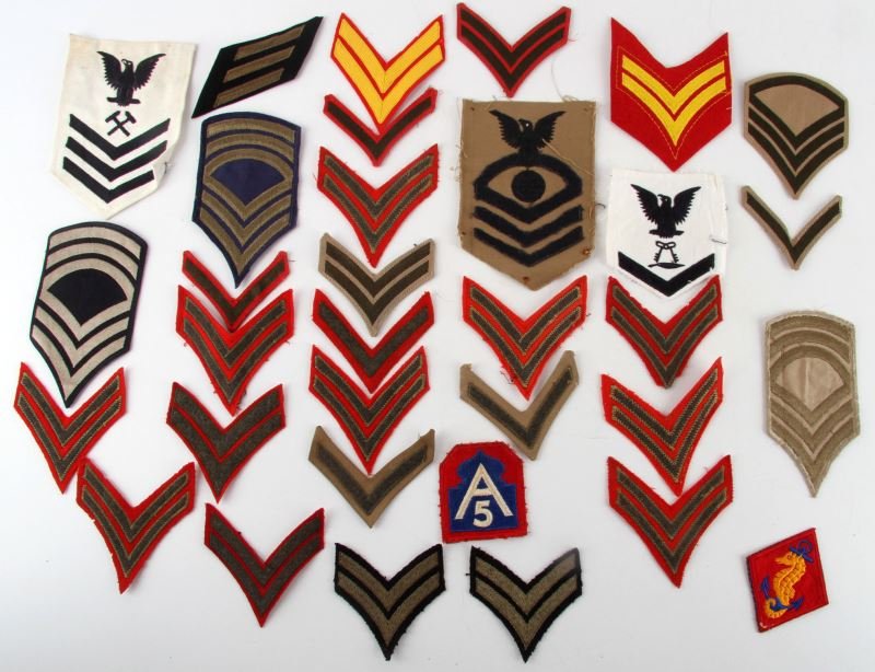 WWI WWII & POST WAR ARMY NAVY MARINE INSIGNIA LOT: Navy CPO and IST class PO are dated 1944 and 1943, early USMC wool along with later sleeve rank insignia, Marine division post war shoulder patch and WWII U.S. Army Corp patch