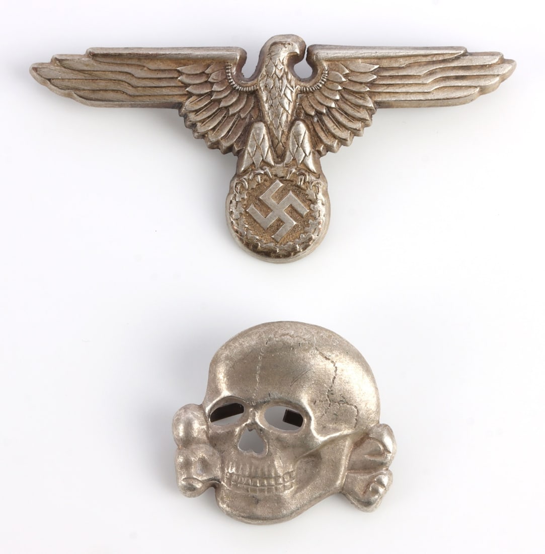 WWII GERMAN SS VISOR PIN SET TOTENKOPF REICHSADLER: Visor pin set for SS officer visor. Skull is marked D.S & M. The eagle is marked M1/8. They measure 2 9/16 and 1 1/16 inches. This lot has a reserve.