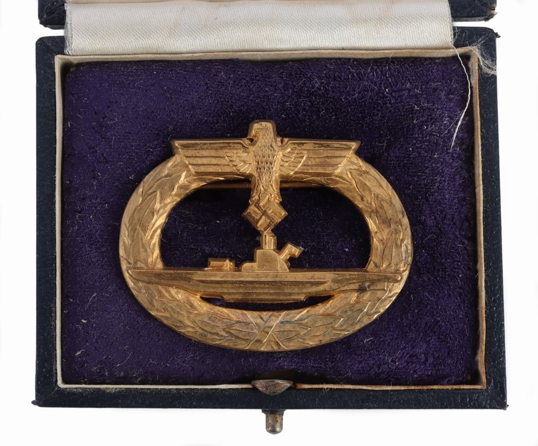 WWII GERMAN THIRD REICH U BOAT BADGE: WWII German U-boat badge in tilted blue case. It measures 1 7/8 inches. Marked W. Deumer and features the horizontal pin. This lot has a reserve.