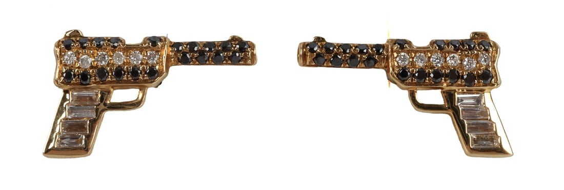 18KT GOLD BLACK AND WHITE DIAMOND PISTOL EARRINGS: 18kt yellow gold pistol earring with black and white diamonds. Stamped 18kt .09 ct. Earring backs are 14kt gold. Size at largest points 0.46 X 0.29 inches. Post 0.5 inches long. This lot has a reserve