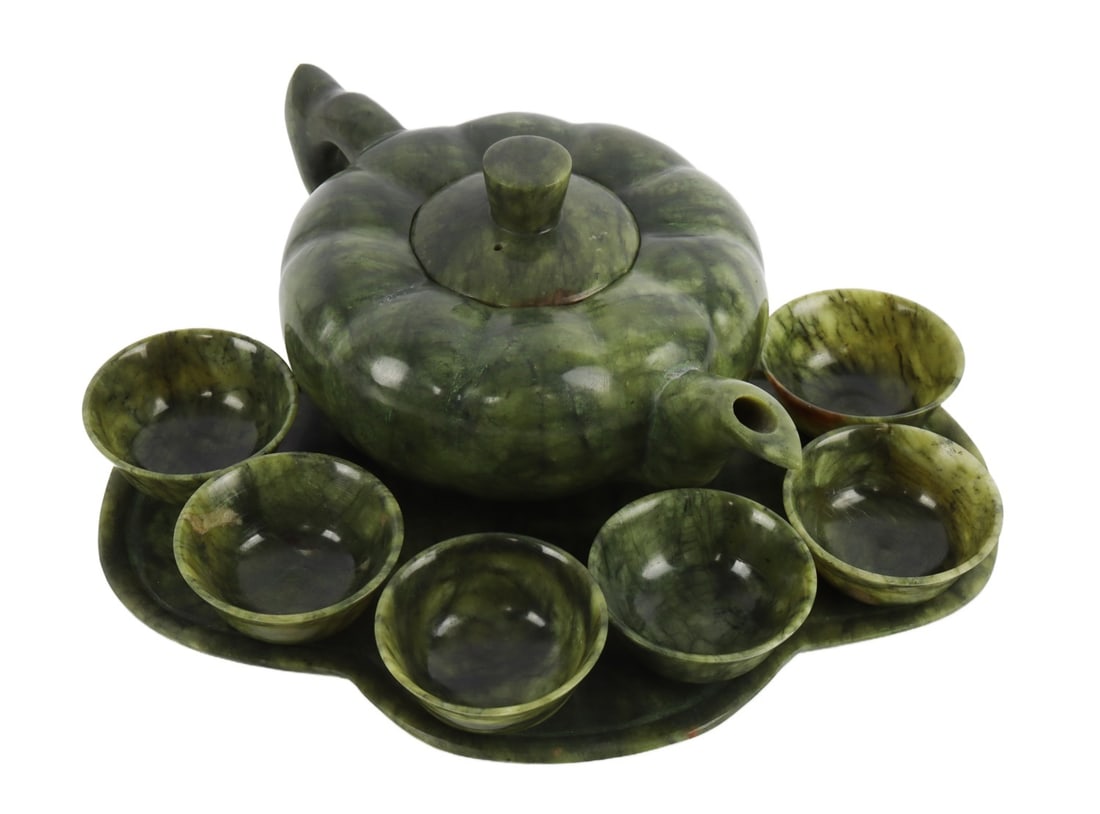 NATURAL GREEN JADE HAND CARVED 8-PIECE TEA SET: Hand-carved natural green jade tea set with 6 cups, tray and teapot. Tray 8x6 inches. Teapot diameter 4.25 inches.