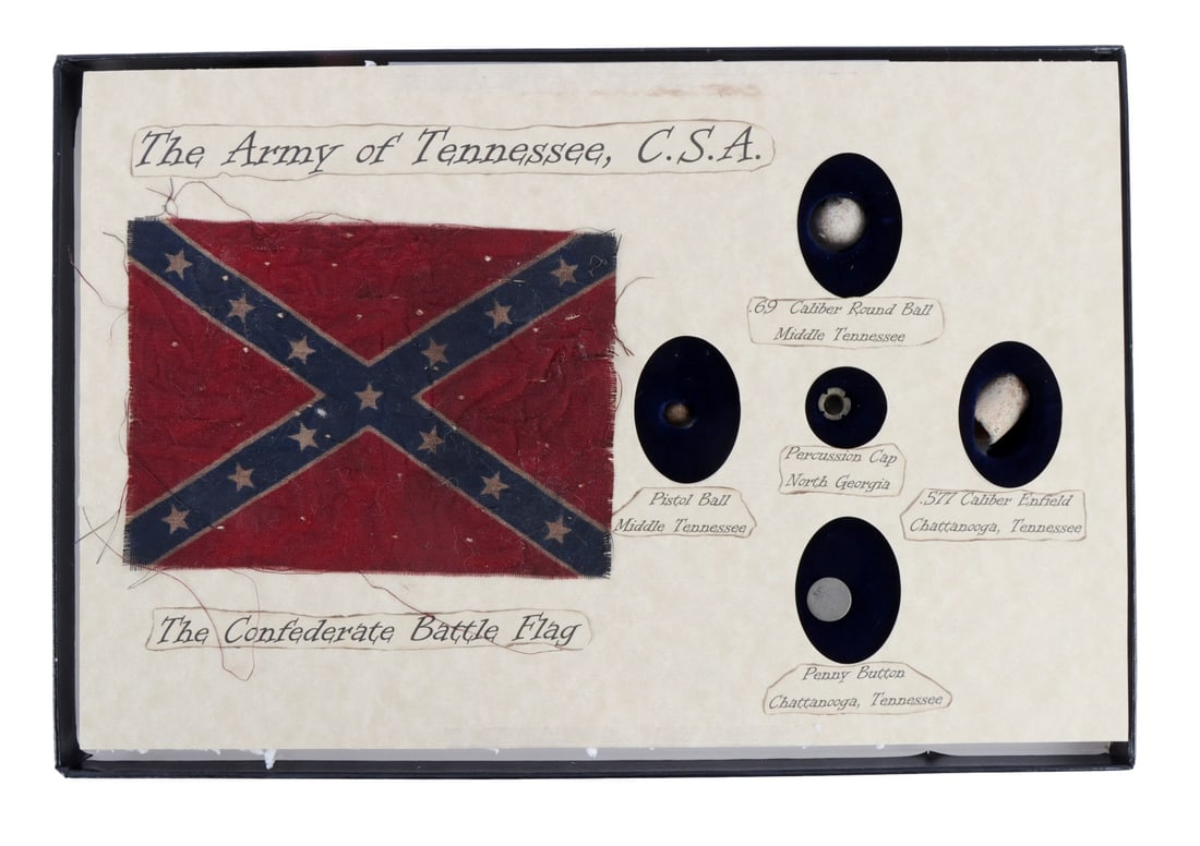 CONFEDERATE ARMY OF TENNESSEE ARTIFACT COLLECTION: Collection of six (6) CSA relics in riker case (8.5 x 12.25 inches). Includes miniature or desk battle flag (4x5.5 inches), .69 caliber round ball, pistol ball, percussion cap, .577 caliber Enfield pr