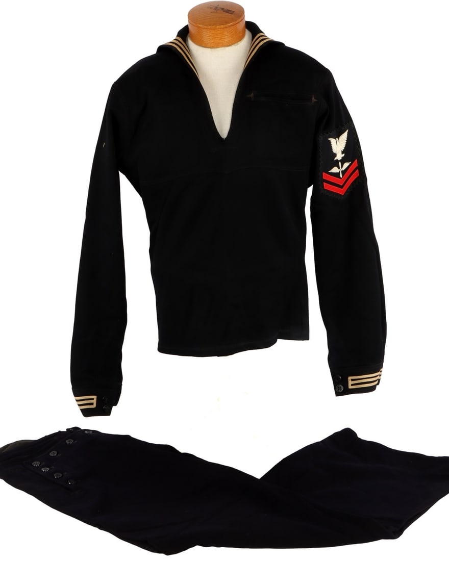 WWII USN NAMED AVIATION MACHINIST DRESS UNIFORM: US Navy sailor's private-purchase gabardine crackerjack jumper and wool 13-button trousers. Jumper has embroidered scrip "AM Piszczek." Trousers also personalized "Piszczek," faintly, in ink. Probably