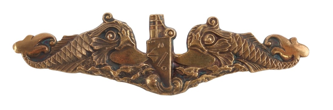 WWII US NAVAL SUBMARINE OFFICER DOLPHIN BADGE: Bronze US Navy submarine dolphin badge for officer in submarine service. Marked Blackington. Measures 2.81 inches. This lot has a reserve.