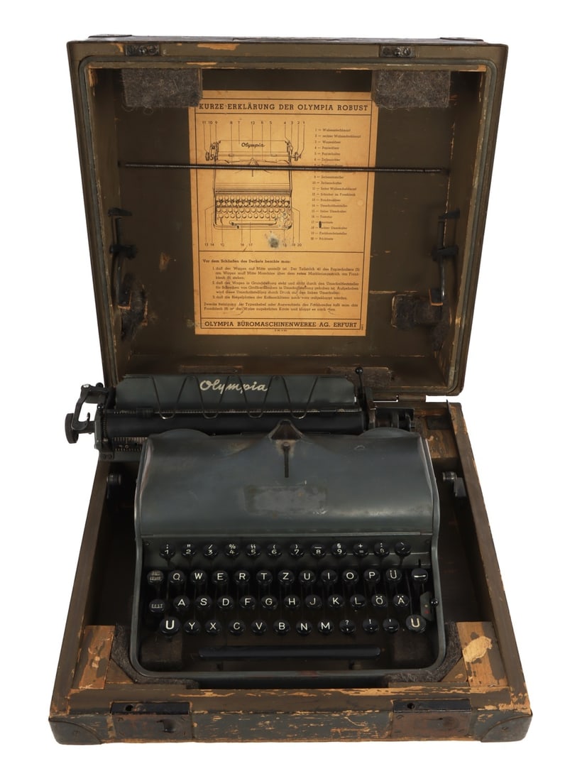 WWII GERMAN SS TYPEWRITER VET BRING BACK: An Olympia branded typewriter, altered by the company to place SS-Siegrunes as an alternate letter for the 5. As the typewriter is painted field gray, it was likely in use by the Wehrmacht or Waffen-S