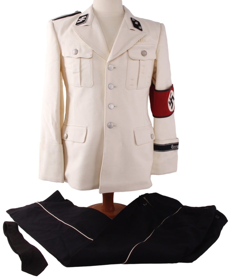 WWII GERMAN 3RD REICH ALLGEMEINE SS SUMMER DRESS: Allgemeine-SS officer's summer uniform white jacket, black trousers, and tie. Jacket bears the collar tab and shoulder boards of an Untersturmfuhrer. It has a black bordered armband attached to the le