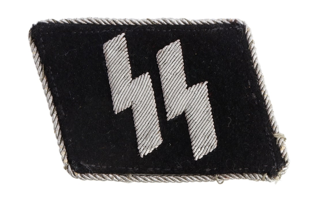 WWII GERMAN THIRD REICH SS COLLAR TAB: A collar tab for a member of the SS, with silver bullion thread and bullion SS-Siegrunes. Non-fluorescing. 2.5 X 2 inches.