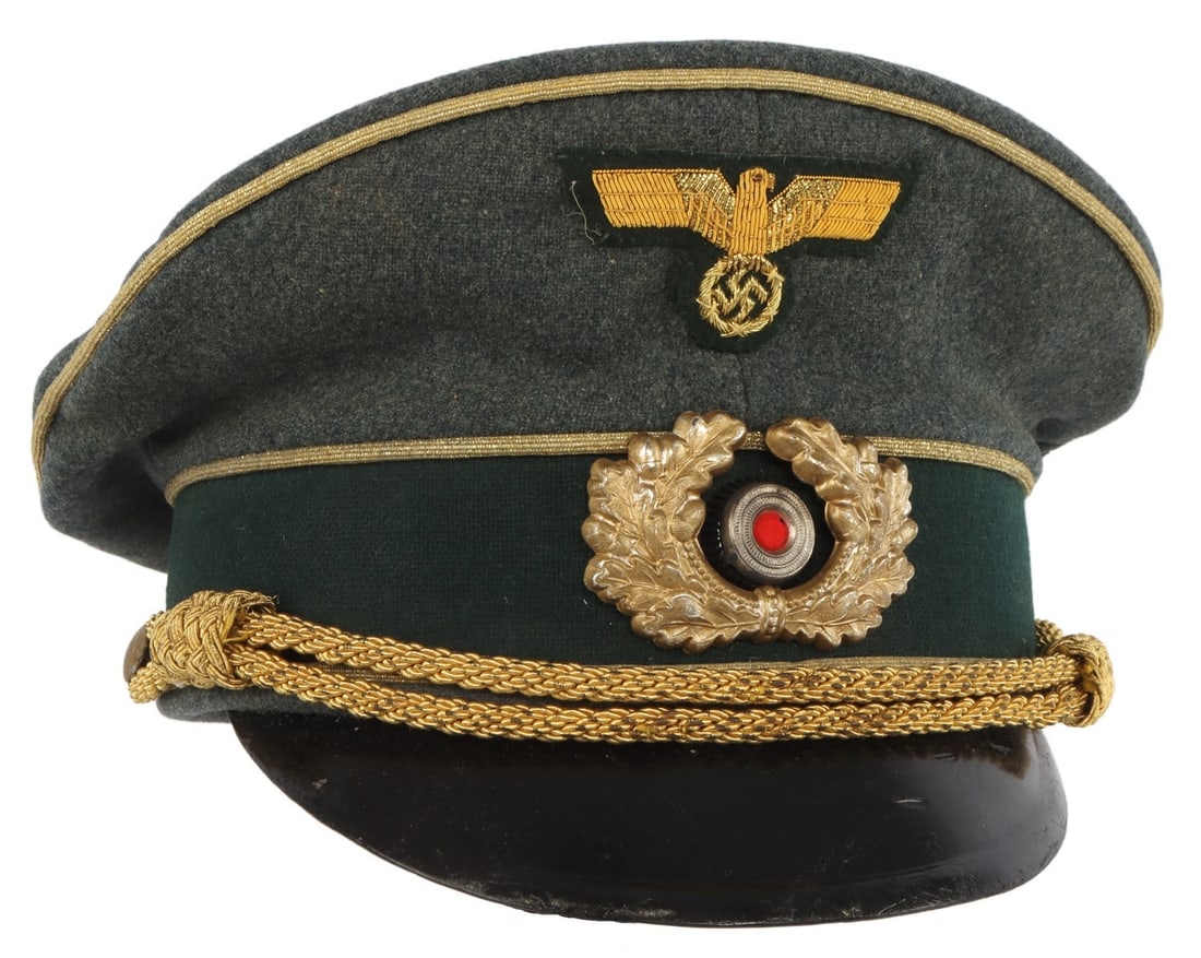 WWII GERMAN THIRD REICH HEER GENERAL VISOR: A visor for a general of the Wehrmacht of the German Third Reich. Field gray cloth with black velvet band. Reichsadler and cockade badges on front. Gold bullion strap. Tight and aligned back seam. Har