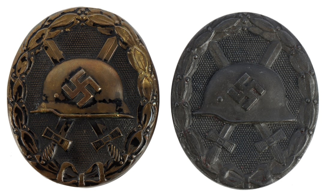 WWII GERMAN WOUND BADGE SILVER & BLACK LOT OF 2: Lot of two (2) wound badges. First, in silver, solid-struck, marked on reverse "30." Second, in black, hollow-struck, unmarked.
