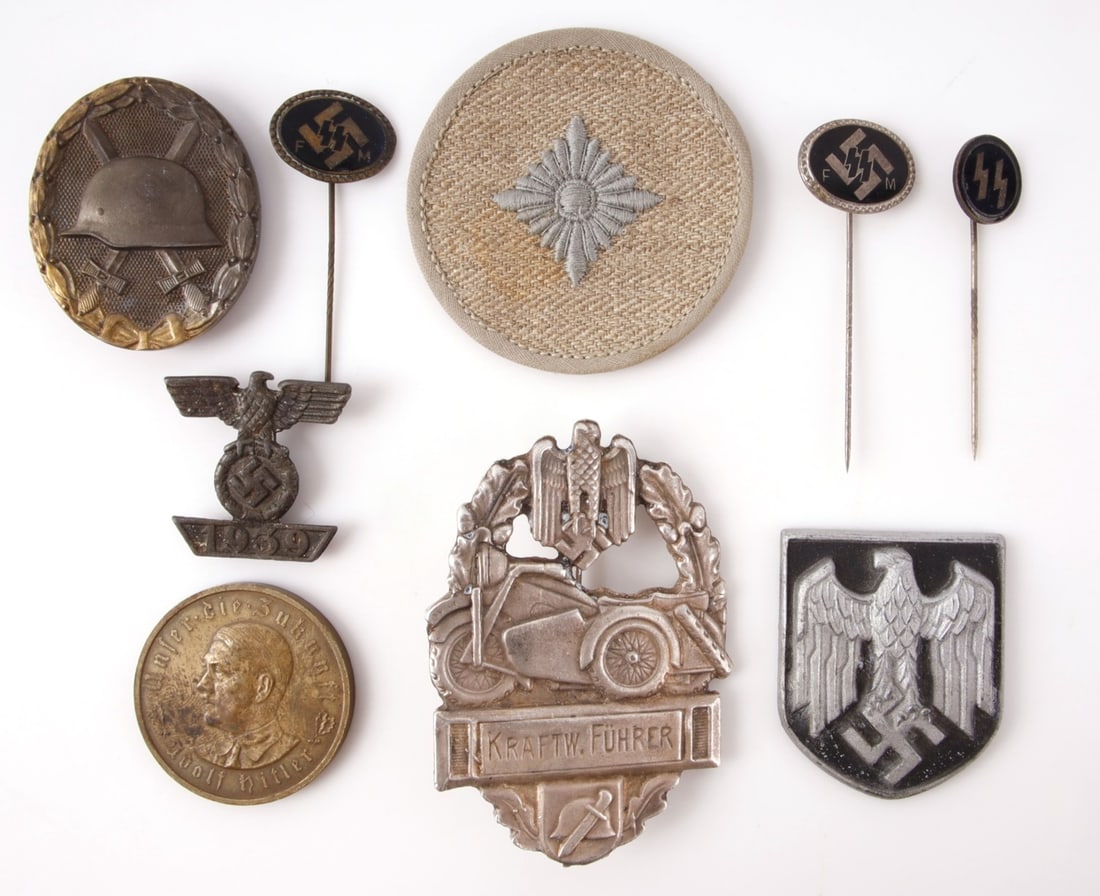 WWII COLLECTION OF THIRD REICH ITEMS LOT OF 9: Nine items with the symbols of the German Third Reich. Pins, patches, and badges, a varied mix.