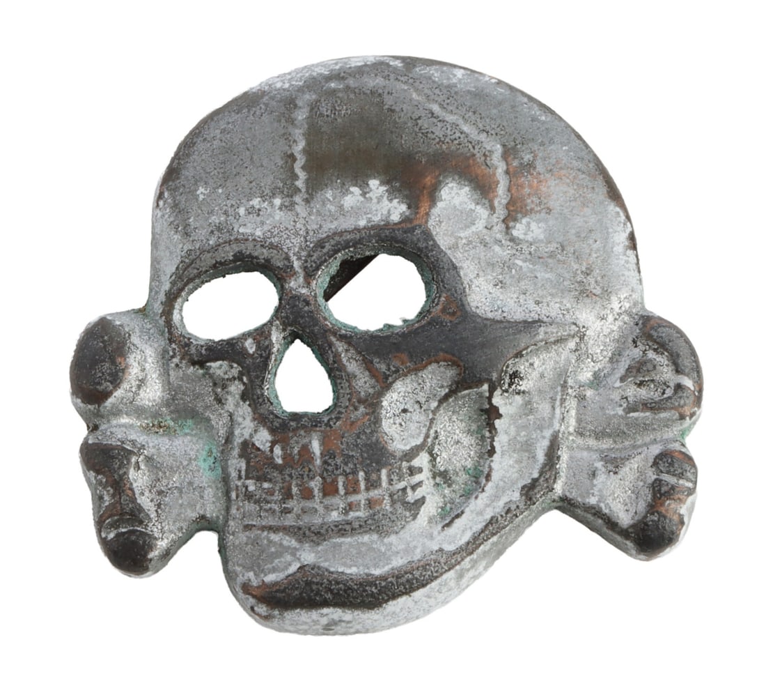 WWII GERMAN THIRD REICH TOTENKOPF VISOR BADGE: A totenkopf visor badge for the SS of the German Third Reich.