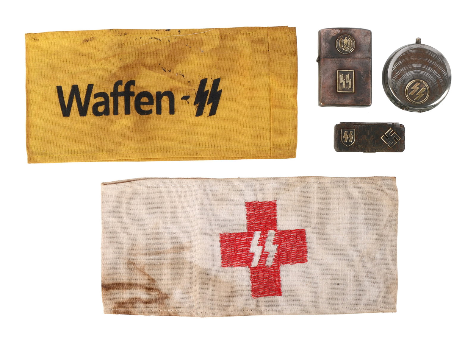 WWII GERMAN THIRD REICH WAFFEN-SS PERSONAL EFFECTS: A selection of five items associated with the Waffen-SS of the German Third Reich. 1) Waffen-SS armband. 2) SS nurse armband. 3) Cigarette lighter. 4) Portable ashtray. 5) Mini pervitin box.