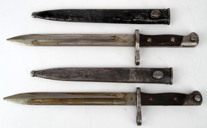 TWO CHILEAN MAUSER BAYONETS: Two Chilean Mauser bayonets with scabbards. WKC, Solingen, some finish loss and dings to scabbard, non-matching, otherwise very good; Bayonet marked "CE" over "WG" on ricasso, blade very good, scabbar