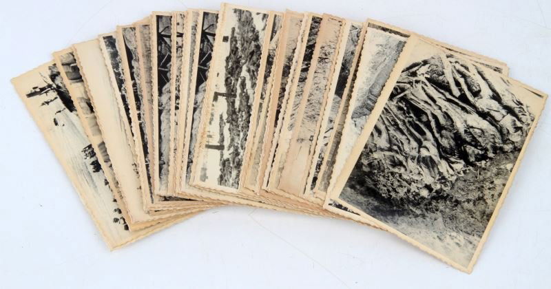 41 PHOTOS OF RUSSIANS UNCOVERING MASS GRAVES: Various photos depicting Russians digging up mass graves. Each photo is stamped "redeemed" on the back. Some bending and yellowing; otherwise in good condition. This lot has a reserve.