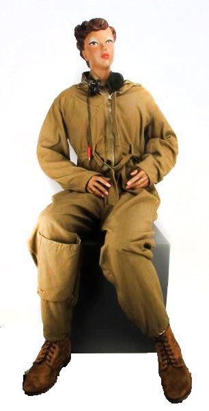 WWII WASP ARMY AIR CORPS WOMAN'S FLIGHT SUIT: Group includes flight suit, tunic, head phones, undershirt, propeller with wings insignia, tie, boots, and a mannequin model to display each piece. Suit has some minor scuffs; otherwise in very good c