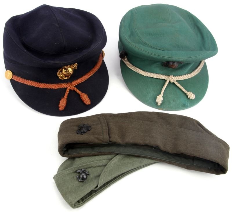 WOMAN USMC MARINES WWII TO VIETNAM HEADGEAR W HBT: Collection includes two garrison hats one being WWII herring bone twill, early with large Cuba EGA block cap , circa Vietnam officers brass EGA block cap. Very good condition.