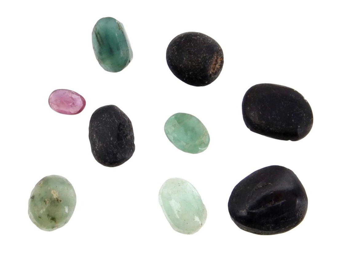 Over 13 Carats of Cut and Raw Gemstones: Total of 13.5 carats. Untested stones. Set has emeralds, agate, ruby, and black spinal. Largest stone is 9.46x7.24x5.6 mm.