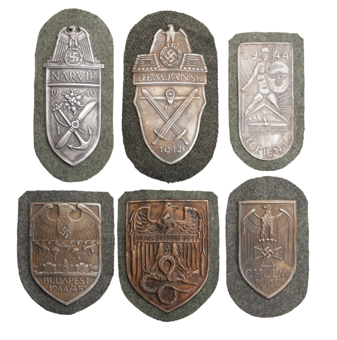 6 Campaign Badges WWII German Reich: Six (6) campaign shields of the German Third Reich: Budapest, Lorient, Cholm, Narvik, Warschau, and Demjansk..