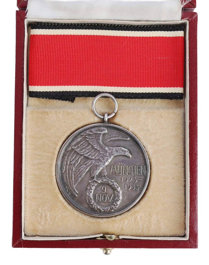 NSDAP Blood Order Medal in Case WWII German Reich: Obverse features eagle with November 9th with Munchen 1923 - 1933. Reverse shows Feldherrnhalle with swastika above. 800 silver marked. Serialized 2500. It measures 1 1/2 inches. Weighs 28.6 grams. Ne