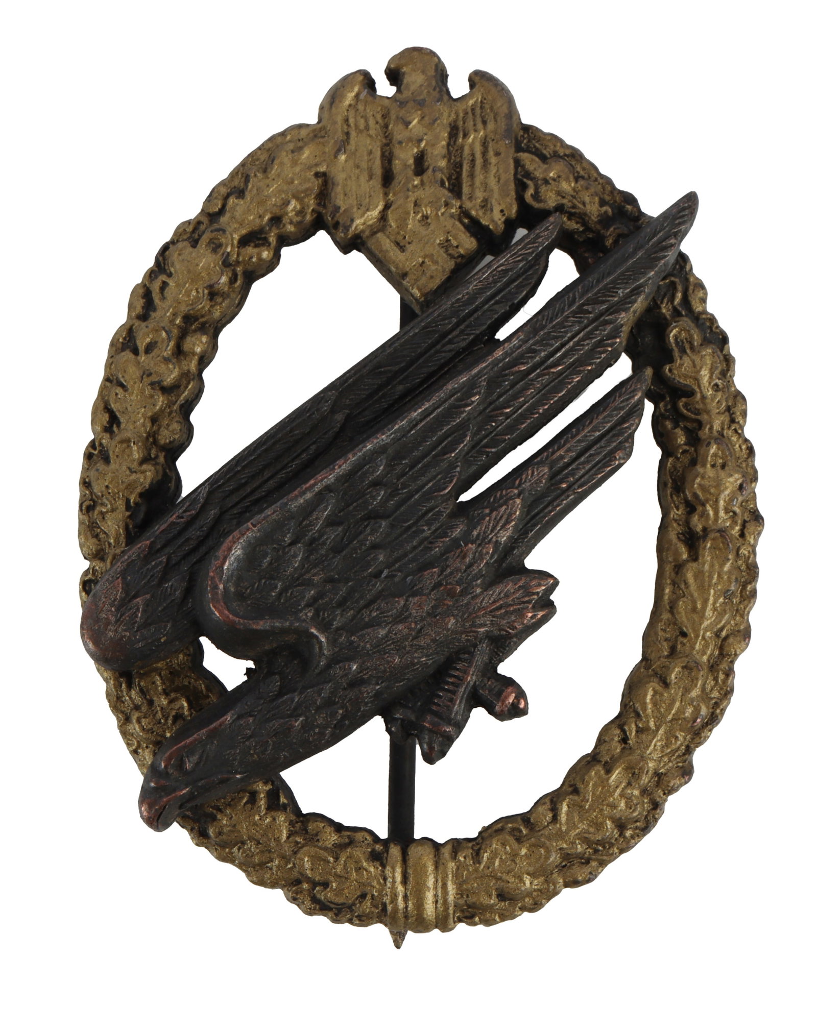 Scarce WWII German Heer Paratrooper Badge: Fallschirm-schutzenabzeichen des Heeres. Late war, solid struck of zinc, gilded and silvered, with reverse having two domed rivets, round wire pin and crimped round wire catch. Reverse of eagle has pa