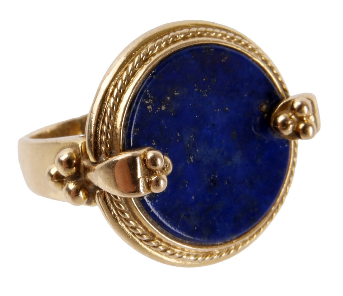 Lapis Lazuli 18K Gold Statement Ring: An 18K gold statement ring with a large lapis lazuli disc. The lapis is a rich, dark blue with some gold-toned calcifications. Size 5. Weighs 8.78 grams. | This lot has a reserve.