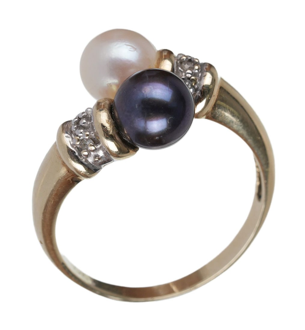 Edwardian Ring Two Pearls in 10K Gold Antique: One black and one white pearl in a swirling Edwardian setting on a 10K gold ring. Stylized "A_" maker's mark but maker unidentified. Size 8. Weighs 3.52 grams. | This lot has a reserve.