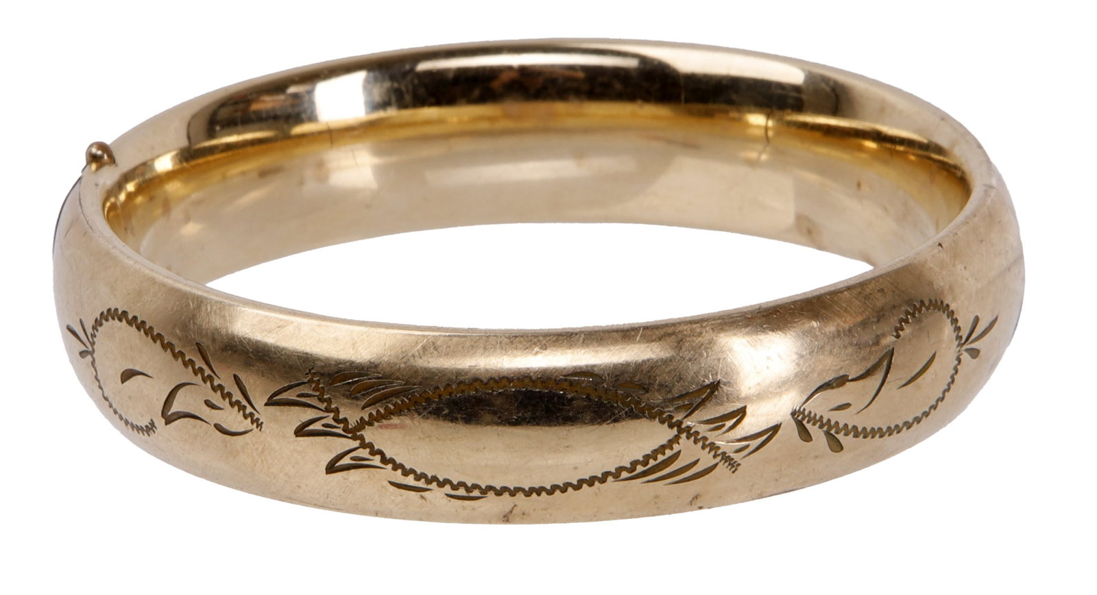 Art Deco Gold Bangle with Etched Design: A bangle etched with a potentially floral design, likely art deco or potentially mid-century modern. Bangle is 1/20 12K gold fill. 9 inches closed. Weighs 24.5 grams. | This lot has a reserve.