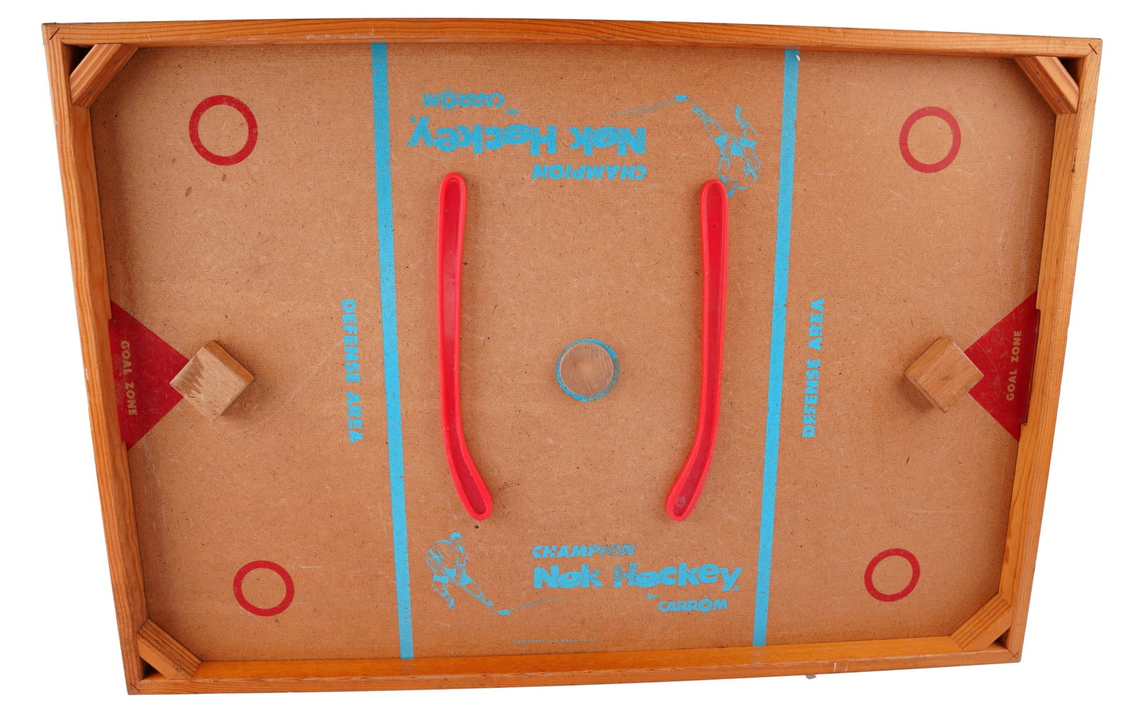 Carrom Nok-Hockey Tabletop Game: A classic mid-century wooden tabletop hockey game manufactured by Carrom Industries of Ludington, Michigan. The board features a rectangular plywood playfield with a solid wood frame and corner reinfo