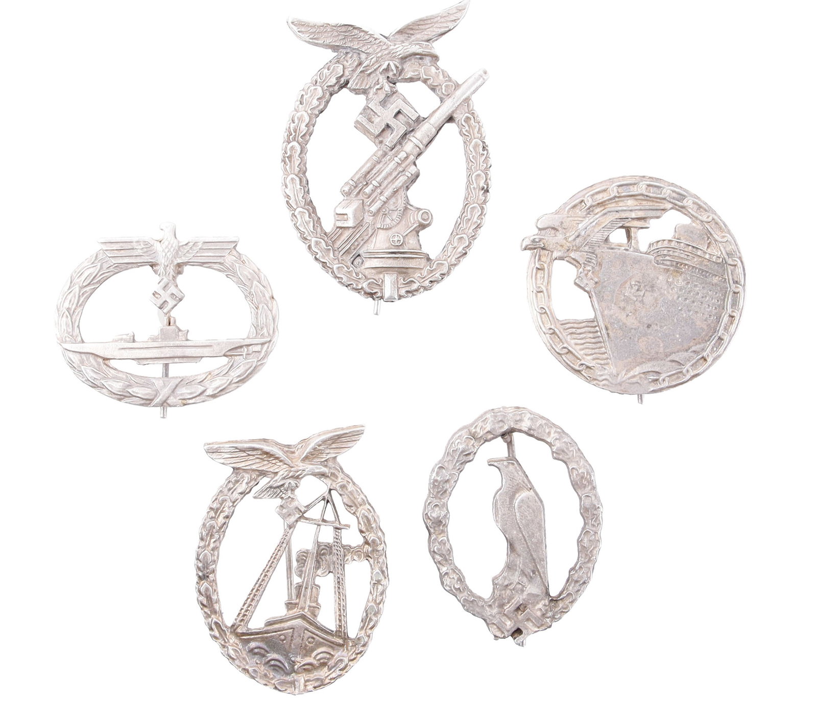 5 WWII German Third Reich Badges: A lot of five (5) badges from the German Third Reich: 1) U-Boat. 2) Blockade runner. 3) Anti-aircraft. 4) Commemorative flyer's. 5) Sea battle.
