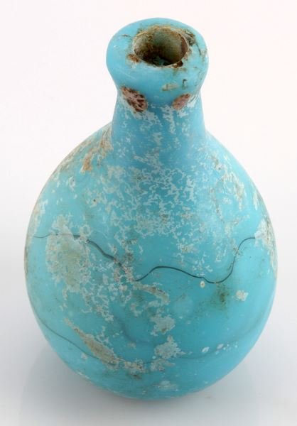 ANCIENT BLUE ROMAN EGYPT GLASS PERFUME BOTTLE: Very good excavated condition powder blue opaque blown perfume bottle, 2000 plus years old, measures four inches.
