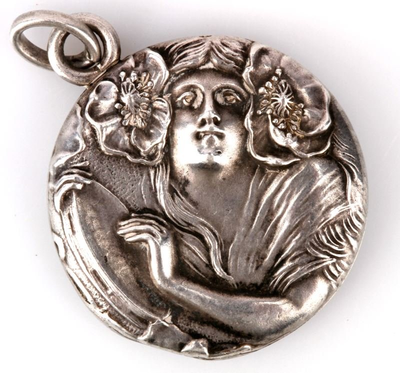 VINTAGE ART NOUVEAU STERLING ENGRAVED LOCKET: Measuring 21.5mm in diameter, hinged at 8 o'clock position. Interior photo frames in good shape. Hand engraving on back. Beautiful example of Art Nouveau-period.