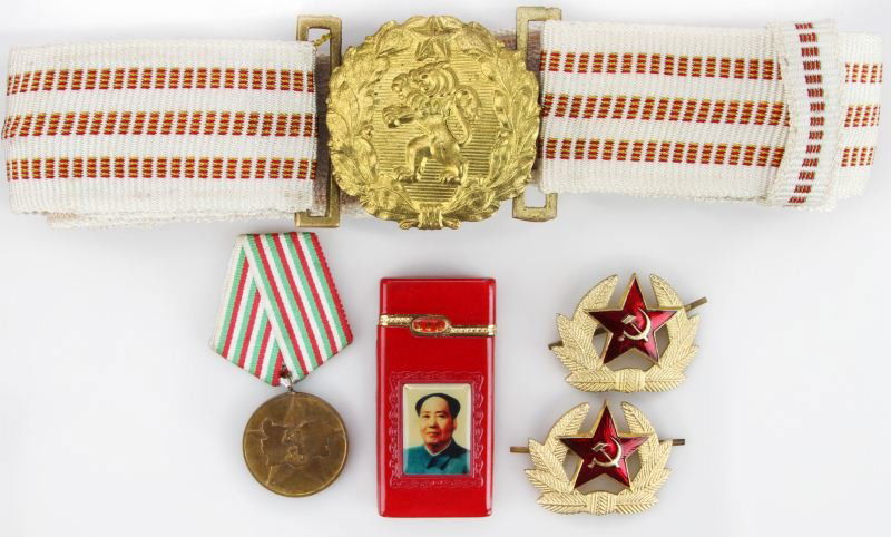 COMMUNIST SET OF RUSSIAN AND CHINESE MILITARIA: Set includes chairman Mao musical lighter, Bulgarian raging lion belt, two USSR soldier's hat emblems, and one Bulgarian raging lion medal. Some light wear to all pieces; overall in very good conditio