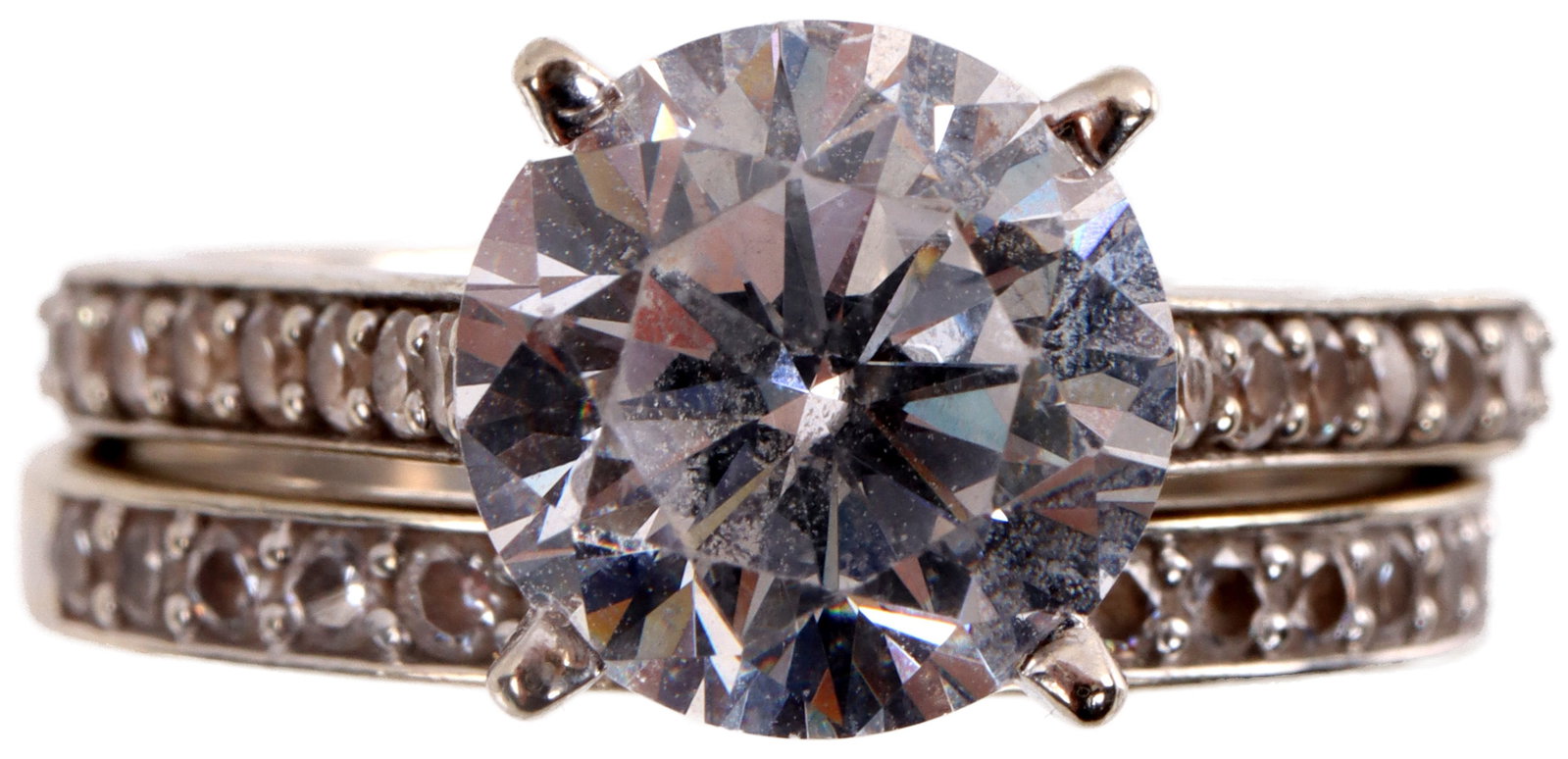 18KT Gold Wedding Ring Set Simulated Diamond: Simulated diamond ring set Both engraved 18KT in shank. Total weight is 9.5 grams. Size 8. Center stone measures 8.99mm X 5.80mm. Flanked by 1.28mm sized stones. Center stone reflects a 3 carat diamon