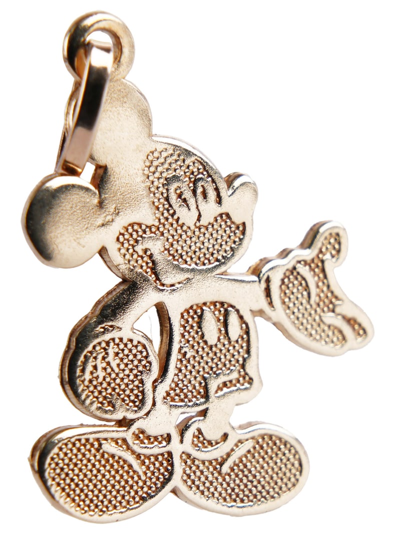 Disney Mickey Mouse Charm 10K Yellow Gold: Classic Mickey Mouse charm made of 10K yellow gold. Stamped on reverse " Disney 10K JCM." Charm measures 0.64x0.5x0.02 inches. This lot has a reserve.
