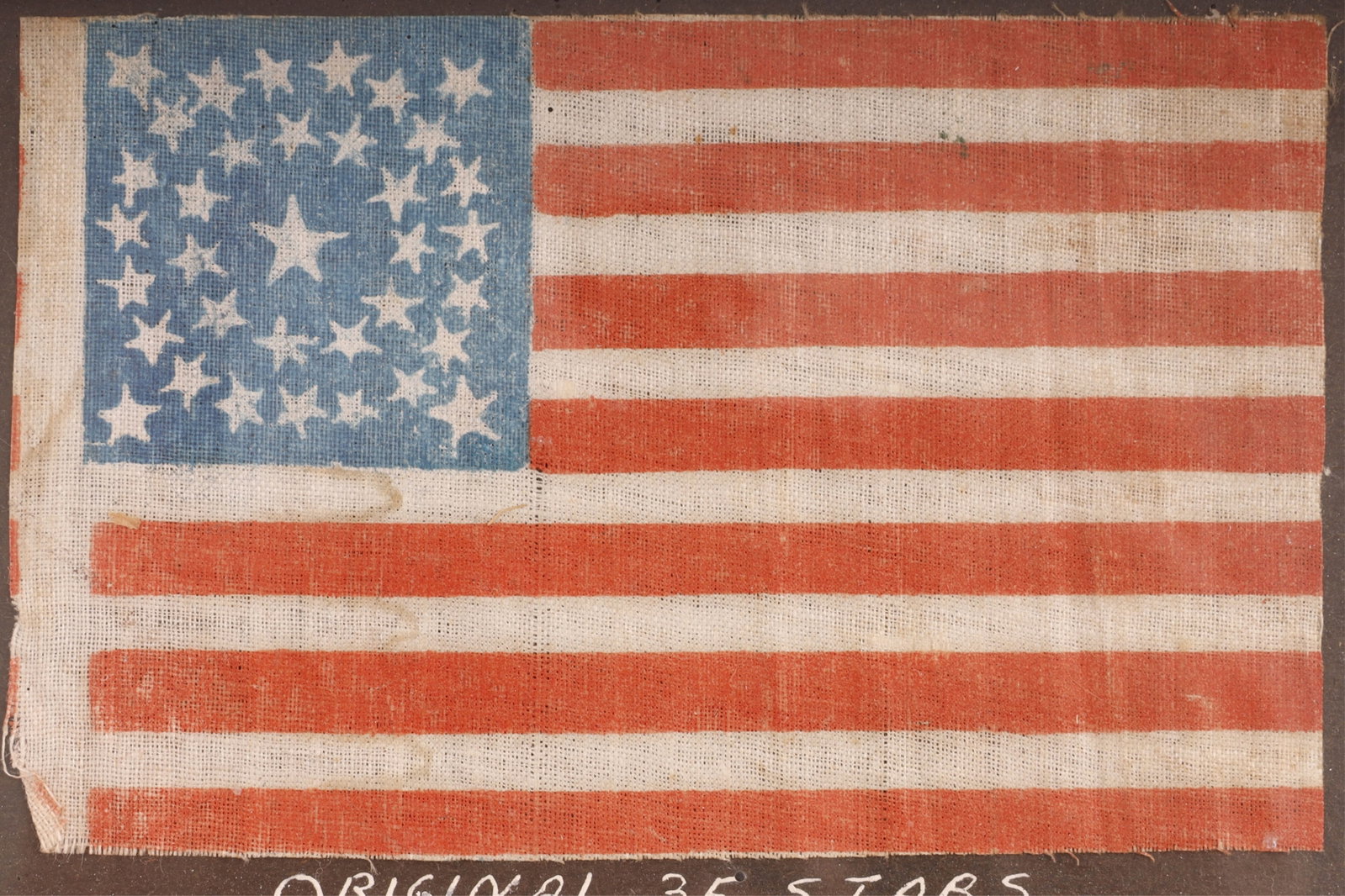 US Civil War 35 Star American Parade Flag: A mid-19th-century Civil War miniature US parade flag, circa 1863?1865. The flag features a blue field with thirty-five stars arranged in a circle. It measures approximately 4.9 X 3 inches and is hous