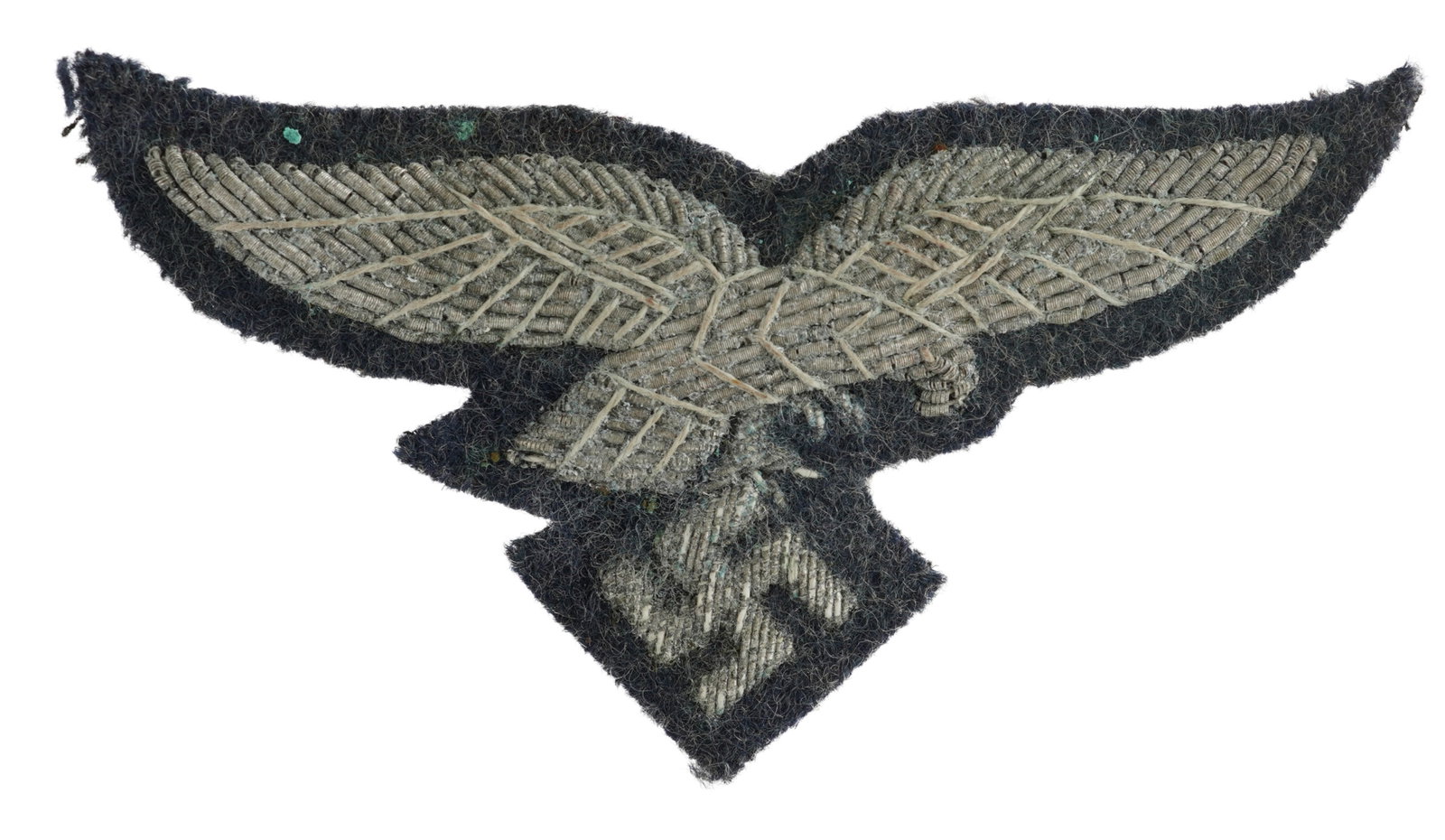WWII Luftwaffe Embroidered Eagle Patch: WWII Luftwaffe Embroidered Eagle Patch. Wool on BeVo backing. Aluminum wire embroidered eagle. Non-fluorescing. Measures 3 inches. This lot has a reserve.