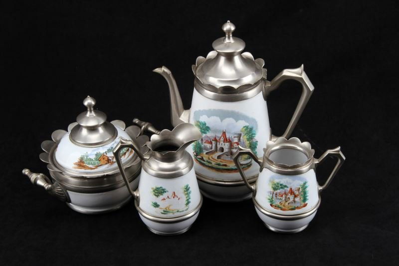 VINTAGE CASTLE SCENE ENAMELWARE COFFEE SET: Five piece set including coffee pot, creamer, sugar bowl plus another sugar bowl with lid (different scene). The scene is a country castle. Large sugar bowl with lid and spoon rest carries rural mount