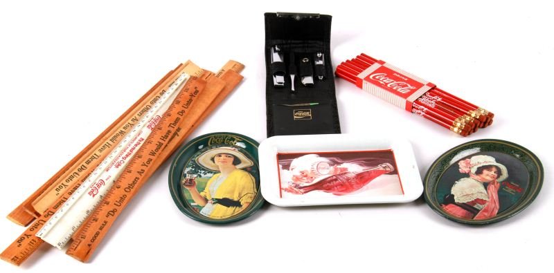 GROUP OF COCA-COLA ADVERTISEMENT ITEMS: Coca-Cola items include a men's grooming kit, twelve pencils, twelve rulers, three tin trays. Overall in very good condition.