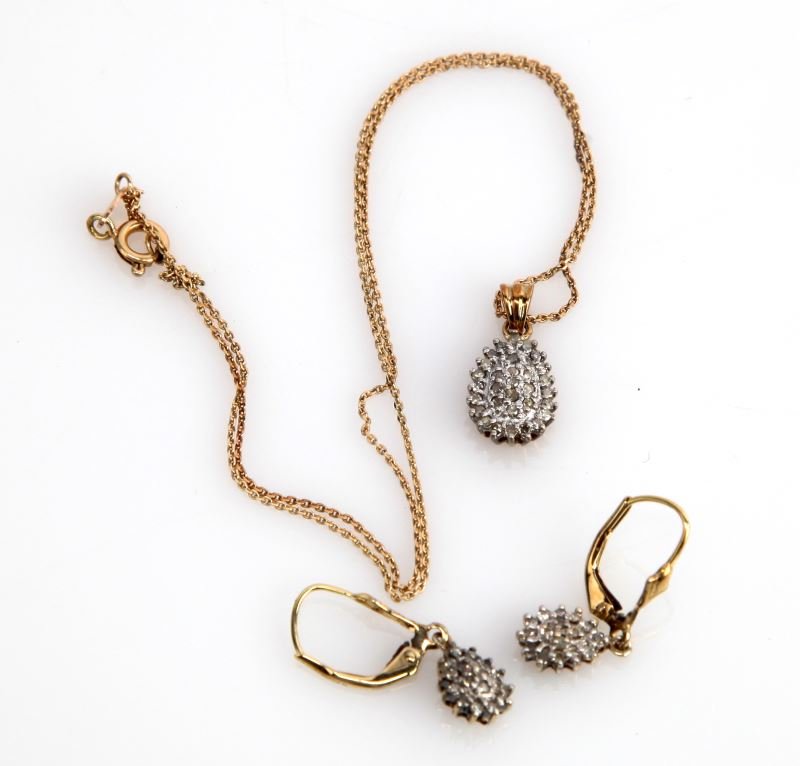 LADIES 10K YELLOW DIAMOND EARRING & PENDANT SET: Three piece set, soft tear-drop design,with 47 round full cut diamonds, bead-set into white gold plate. Each stone weighs approximately .015ct, for an approximate total diamond weight of .66cts, grade