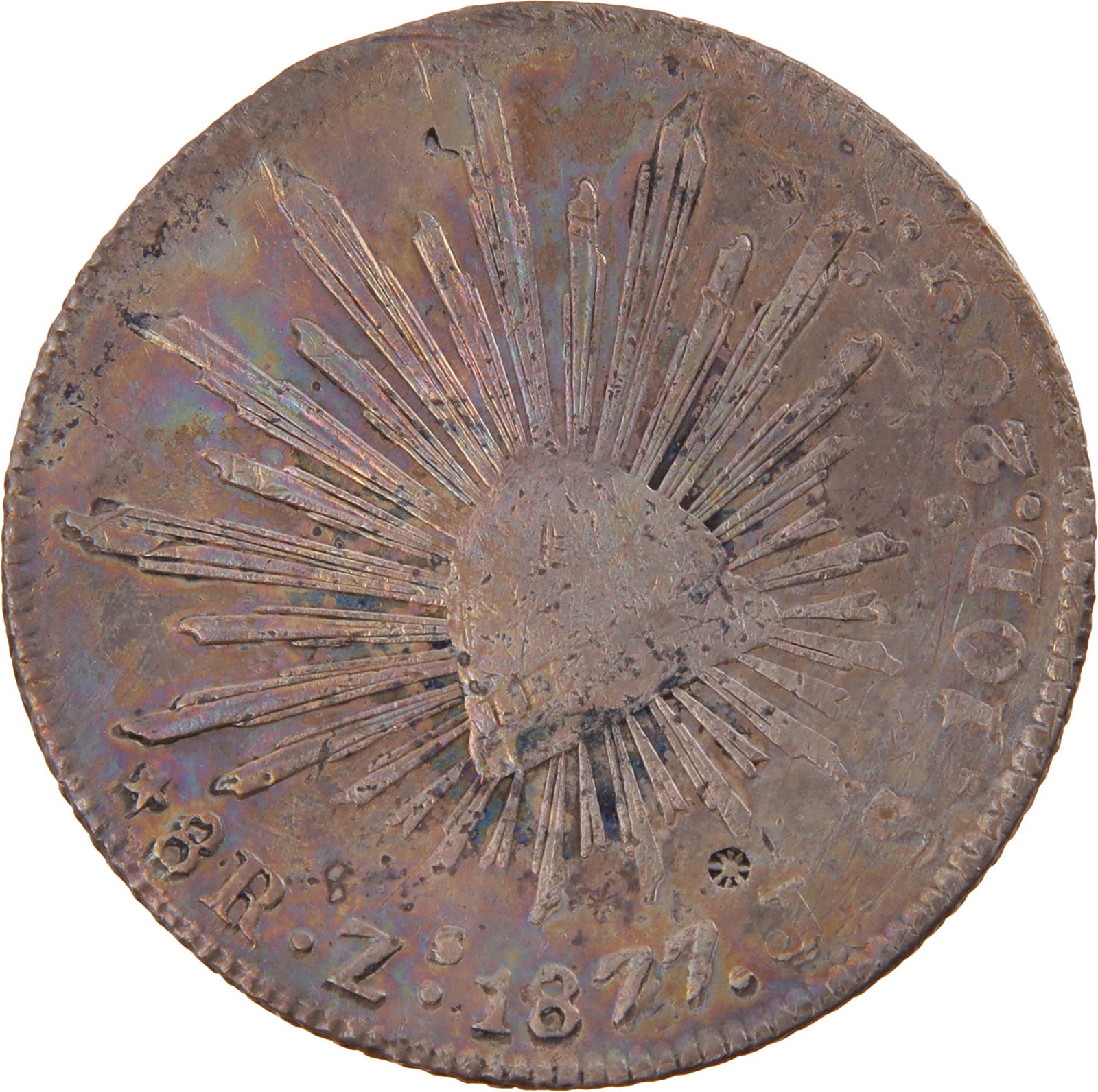 1877 Mexico 8 Reales Silver Coin Rainbow Tone: 1877 8 Reales from Mexico. Zacatecas Mint. Cap & Rays Design. 1.53 inches diameter. 27g. 0.903 Silver. Features natural rainbow toning on both obverse and reverse. Metal: Silver Country of Origin: Mex