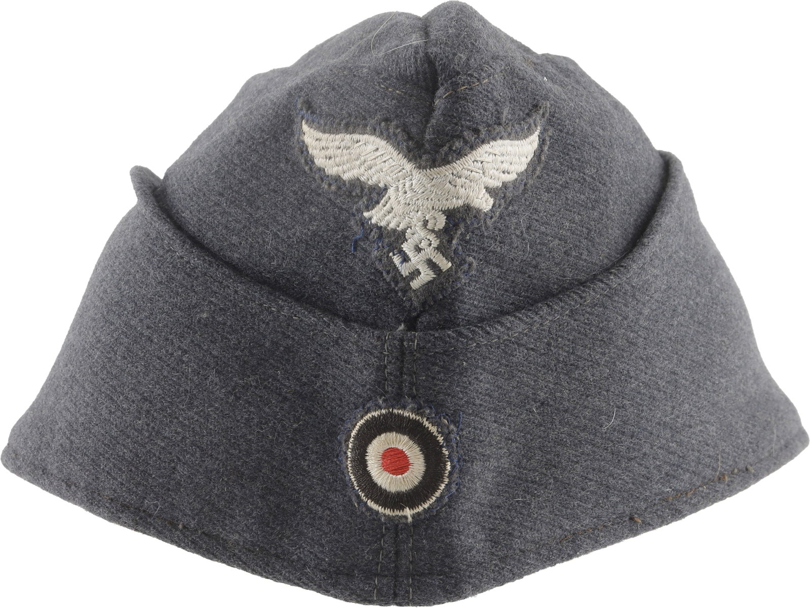 Luftwaffe EM Overseas Cap WWII German: Blue grey wool with Luftwaffe eagle patch and cockade patch. Interior is rayon with an ink stamp on left side. It measures 10 3/4 inches overall. Non-fluorescing.