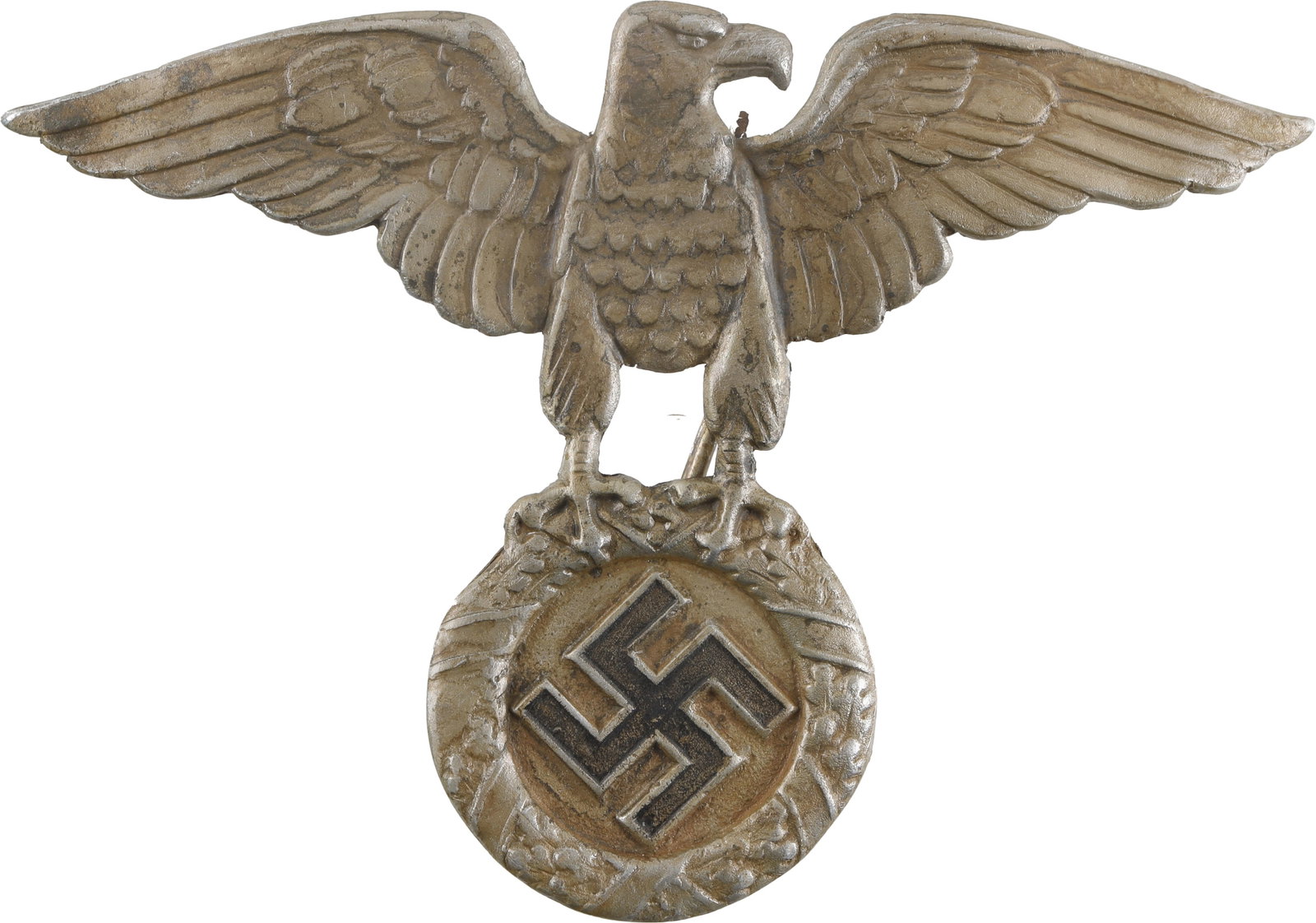 NSKK Crash Helmet Badge First Model WWII German: A first model NSKK crash helmet badge featuring a Reichsadler clutching a swastika.