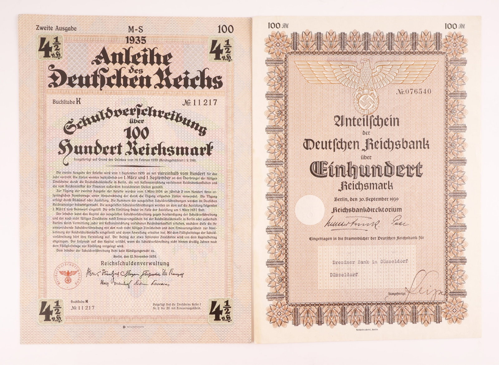 Visually Striking Third Reich Bond Certificates: Lot of two (2) visually striking Third Reich bond certificates ideal for display framing. First, a 1939 100 Reichsmark share certificate Anteilschein, number 076540, issued by the Deutschen Reichsbank