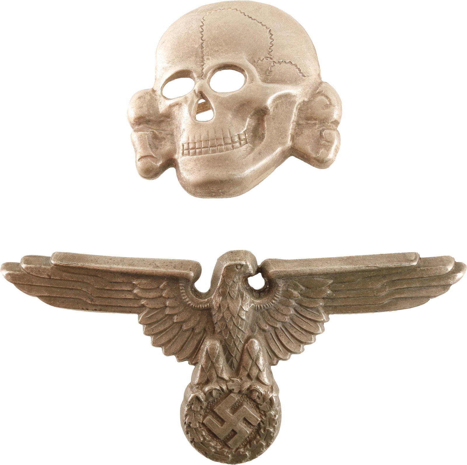 SS Officer Visor Pin Set WWII German Reich: SS Officer totenkopf and reichsadler. Both are nickel silver and non-magnetic. Skull measures 29.7mm. Eagle measures 68.05mm. Both marked M1/24. | This lot has a reserve.