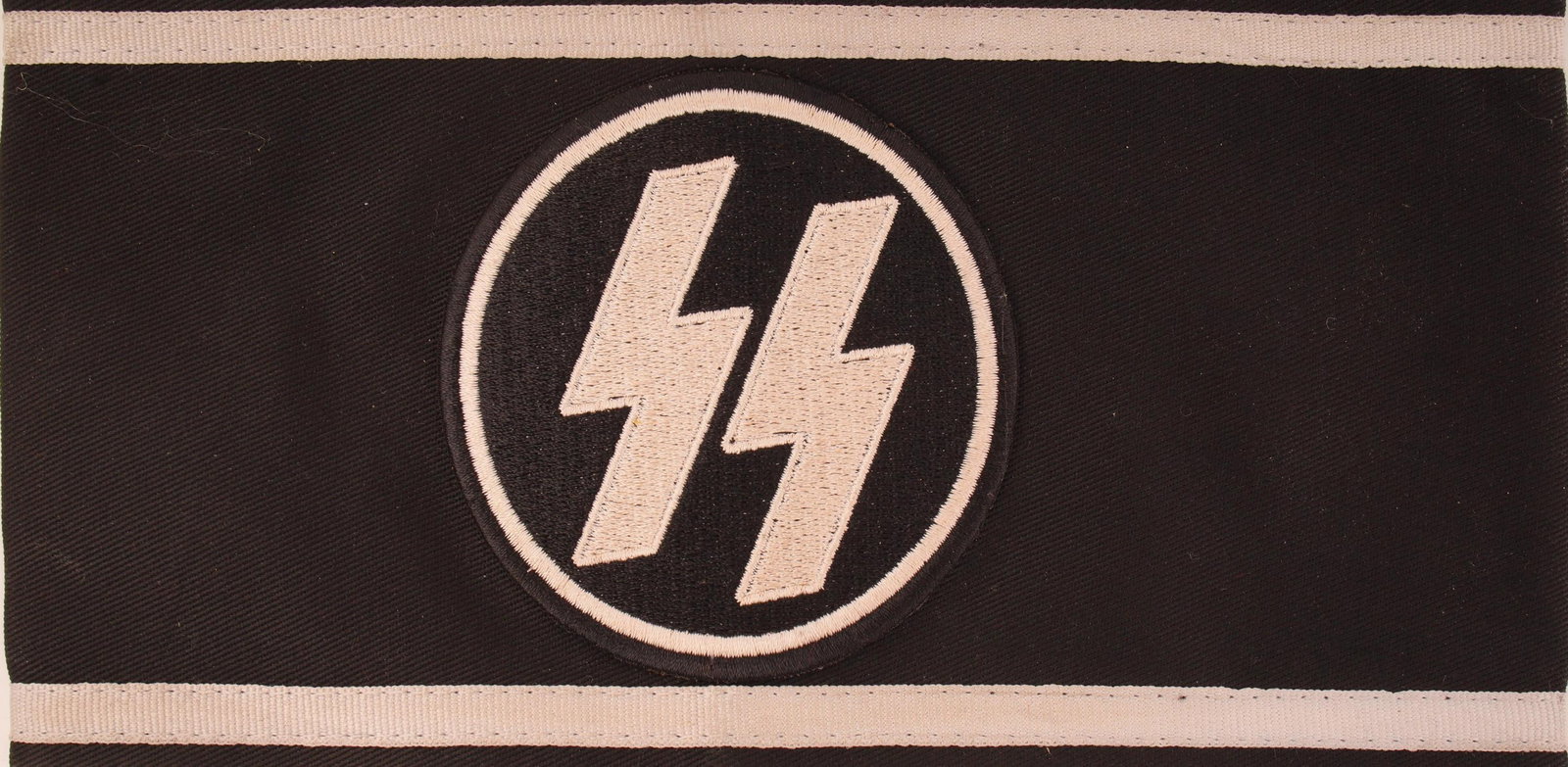 WWII SS Mourning Band Trauerflor Third Reich: A black Trauerflor armband, worn by members of the Schutzstaffel (SS) or displayed over the swastika armband. Construction is black fabric with white trim, and a white embroidered runic SS insigne pat